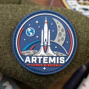 Antsiuvas „Artemis“ iš PaganEDC – 2D PVC kosmoso tematikos antsiuvas su raketos ir mėnulio dizainu, 6 cm dydžio, su Velcro pagrindu.